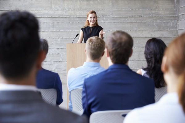 Businesswoman Addressing Delegates At Conference