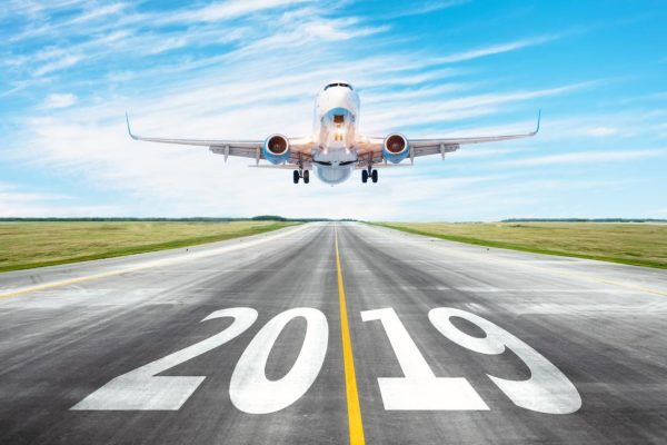 Yhe runway 2019 surface of the airport runway texture with take off airplane. Concept of travel in the new year, holidays.
