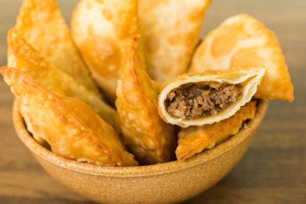 meat pastel under wooden table - delicious homemade fried food easy to prepare