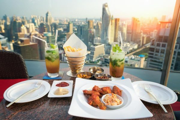 Food, snacks and mojito cocktail on the deak in rooftop bar
