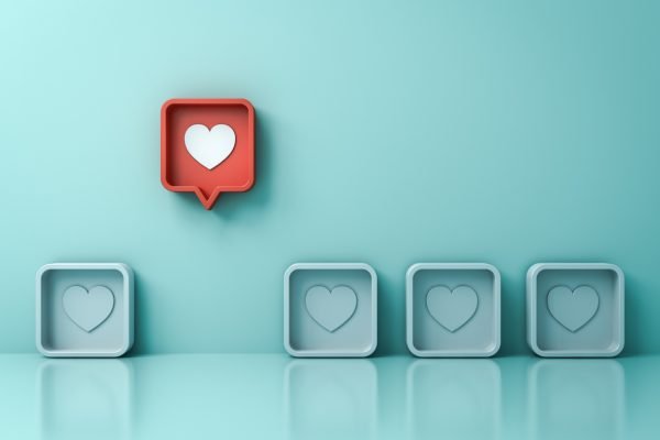 Stand out from the crowd and different creative idea concepts One red 3d social media notification love like heart pin icon pop up from others on light green pastel color wall background 3D rendering